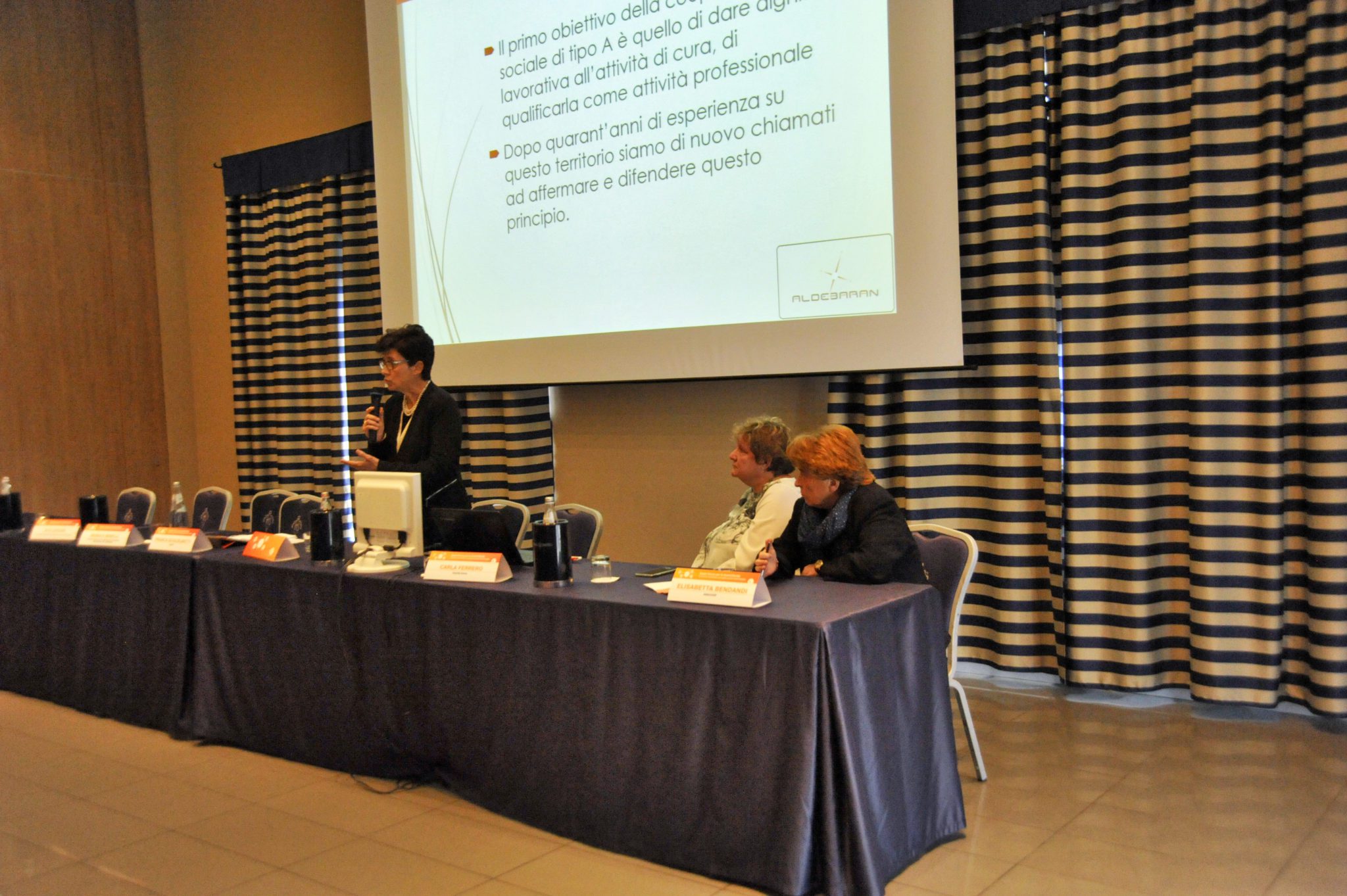 Un'immagine che ritrae mobilia, sedia, evento, tenda e sala.