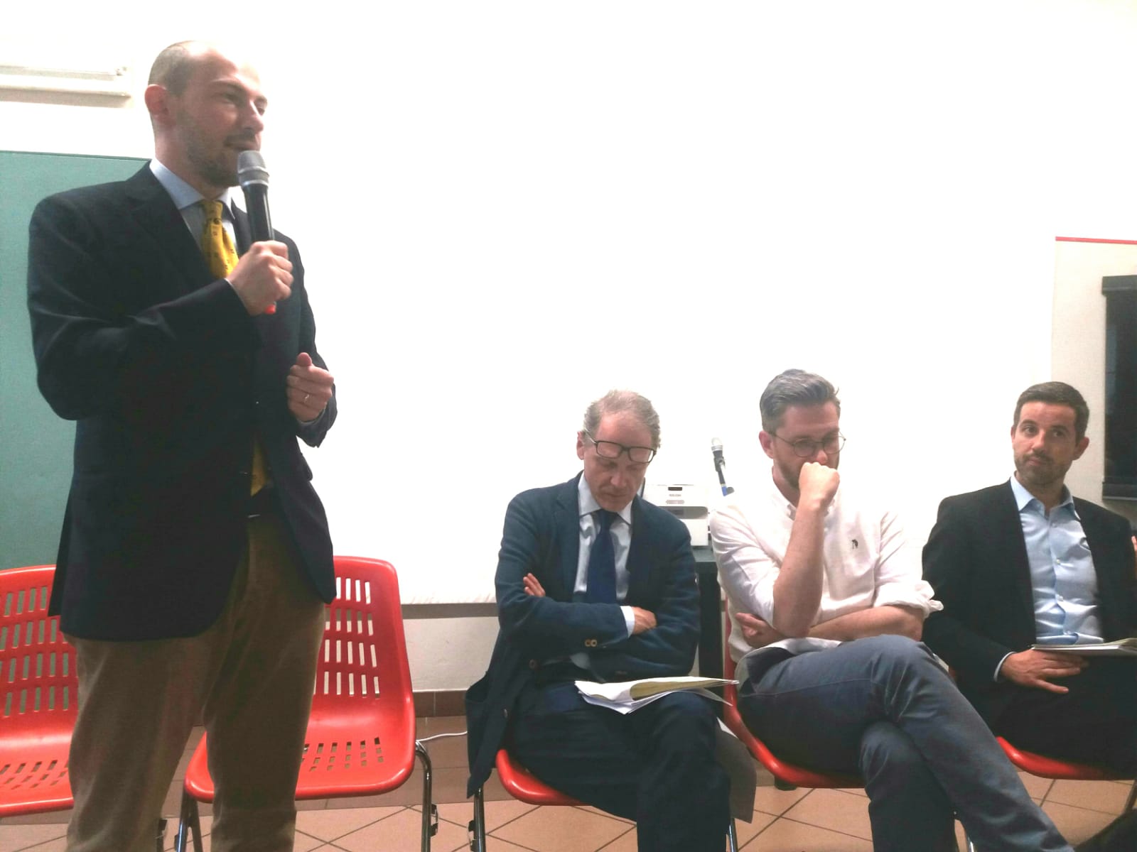 Un'immagine che ritrae pantaloni, mobilia, blazer, abbigliamento formale e abito.